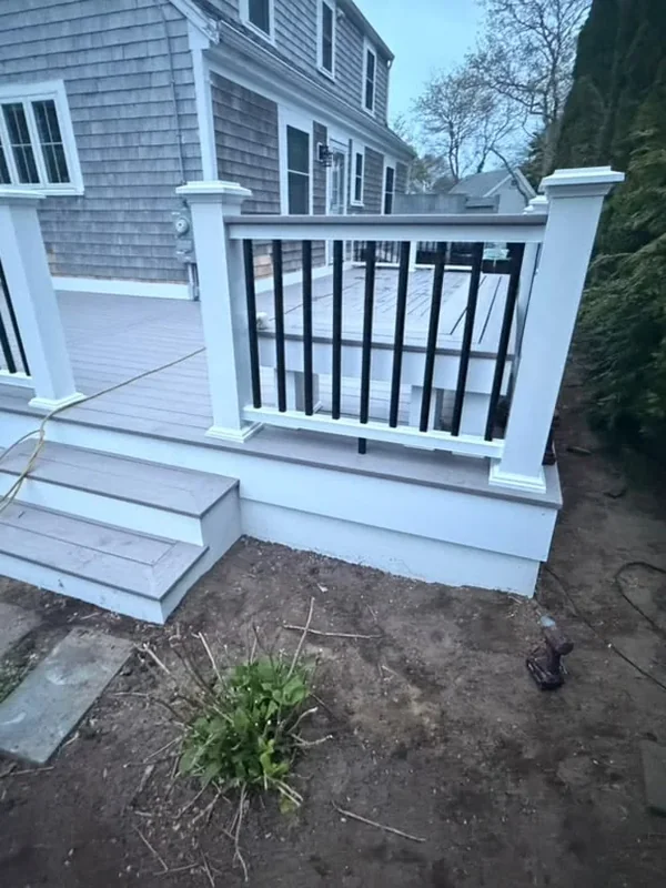 Deck stairs and white railing at the back entrance