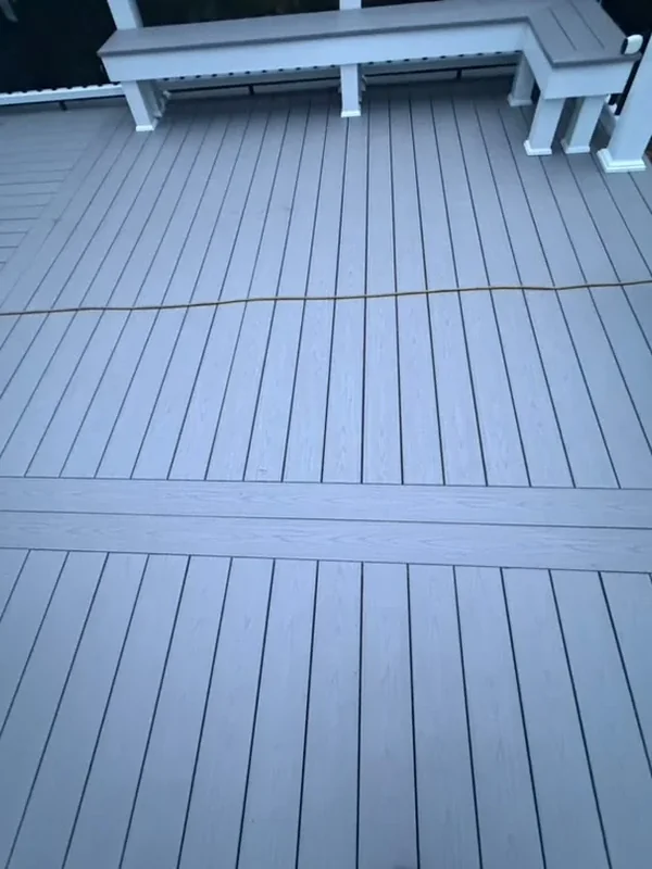 Close-up of gray composite deck boards and white posts