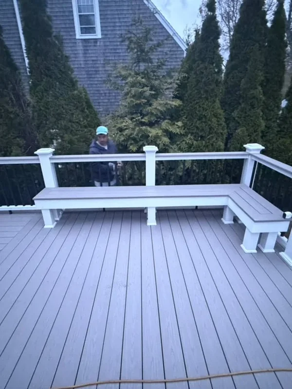 Composite deck surface enclosed by white and black railing