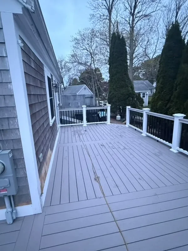 Side view across a composite deck with white railings