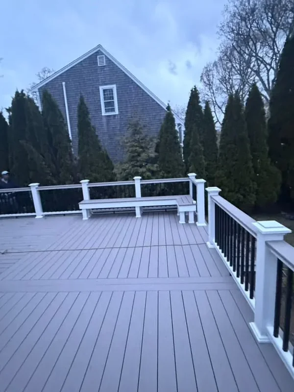 Deck railing and built-in bench on a sunny patio