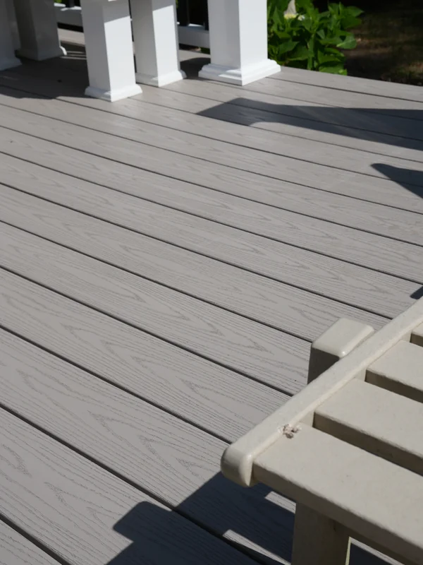 Close-up of gray composite deck boards in sunlight