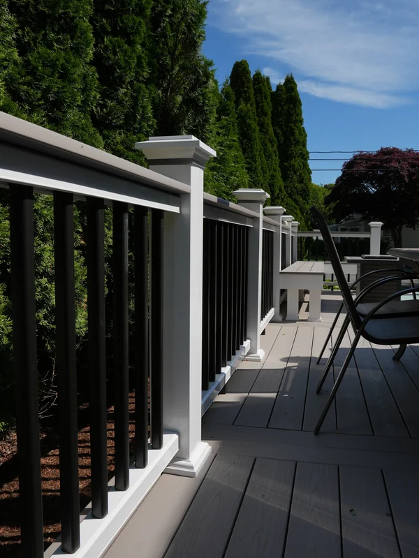 Long deck walkway with railing and outdoor seating