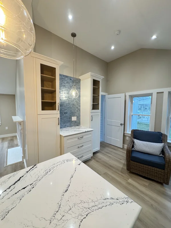 Kitchen and living area with island, pendant lights, and seating