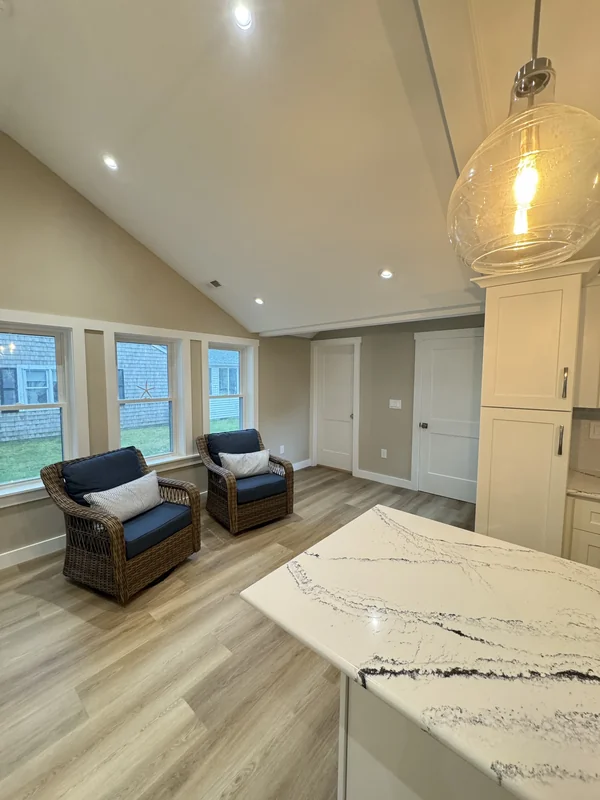 Open kitchen and living space with marble-style island countertop