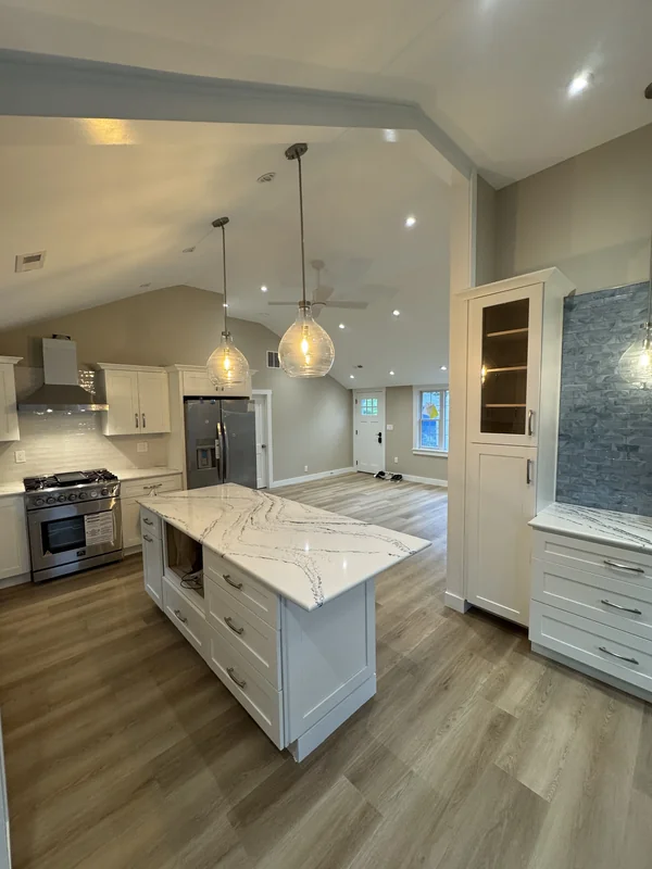 Modern kitchen with white island and pendant lighting