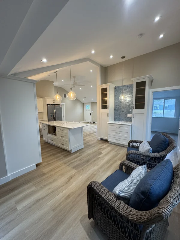 Bright kitchen with island, cabinetry, and open living area