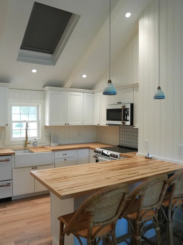 Kitchen island and vaulted ceiling with skylight