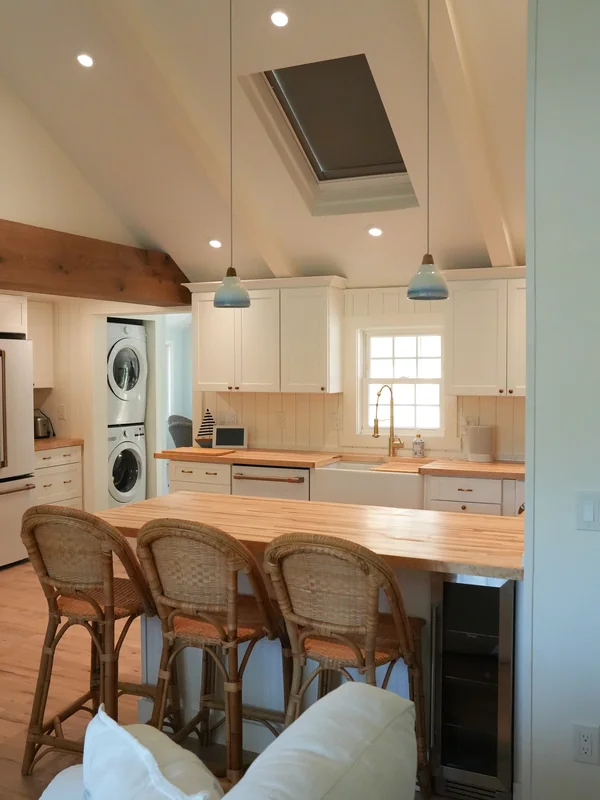 Kitchen island seating with pendant lights and wood countertop