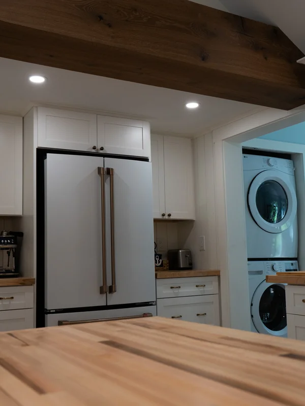 Kitchen countertop facing refrigerator and laundry area