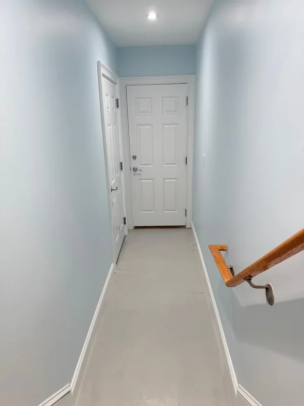 Freshly painted narrow hallway with white trim