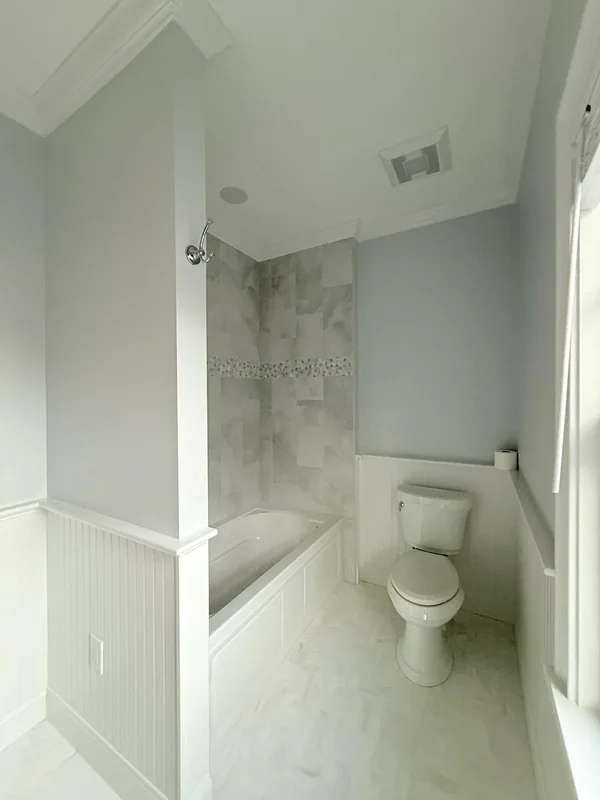 Bathroom with freshly painted light walls and shower area