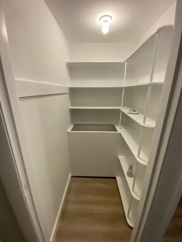 Freshly painted walk-in closet with shelves