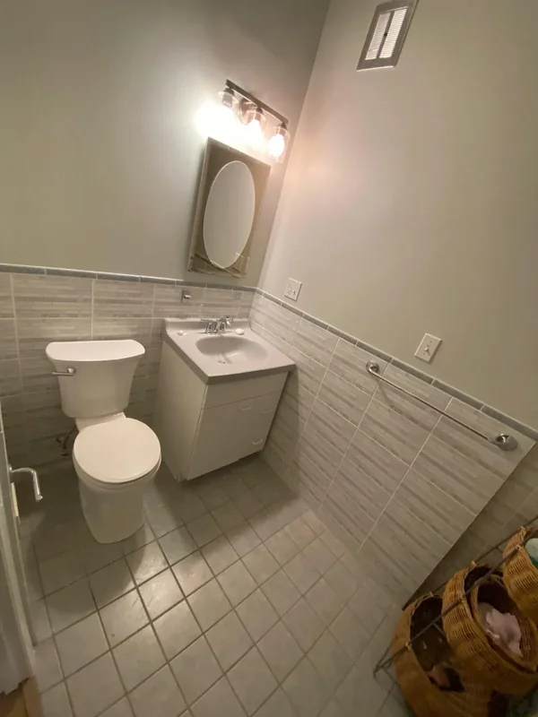 Bathroom with updated wall paint, vanity, and tile