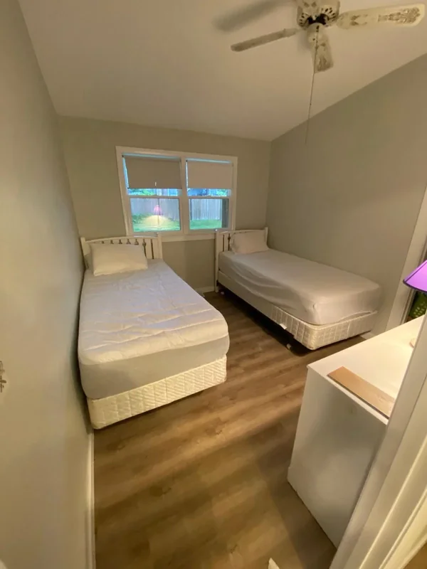 Bedroom with fresh neutral wall paint and wood flooring