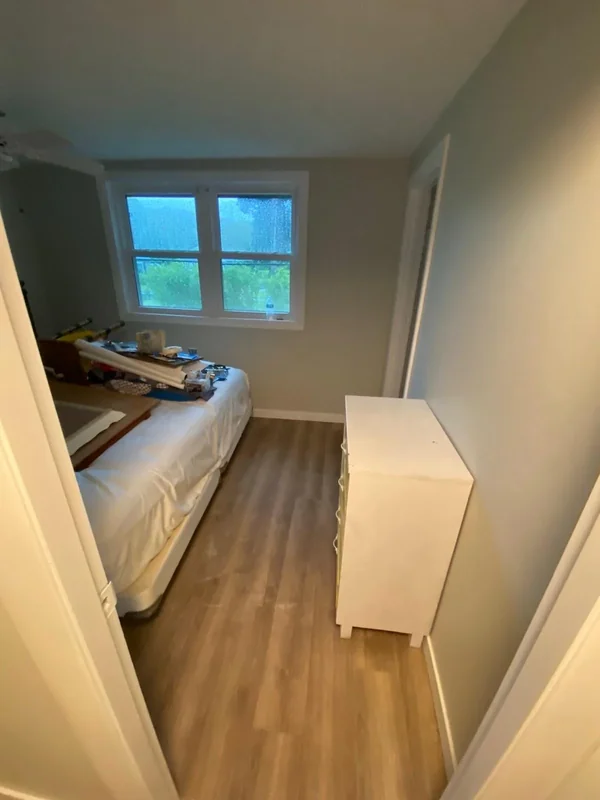 Small bedroom with freshly painted walls and window
