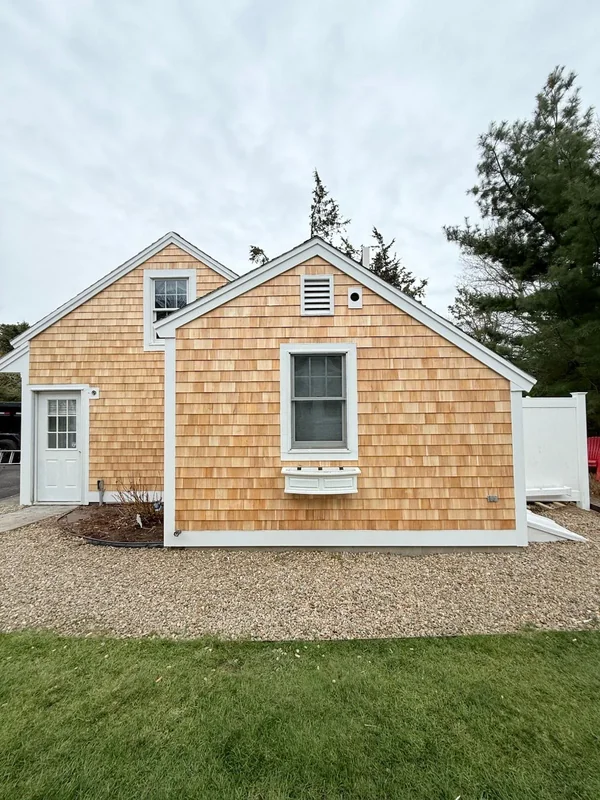 Finished cedar shingle siding on a small building exterior