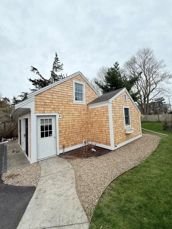 Side view of a finished cedar shingle exterior and walkway