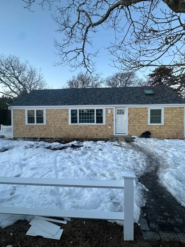 Finished home exterior with cedar shingles and snowy yard