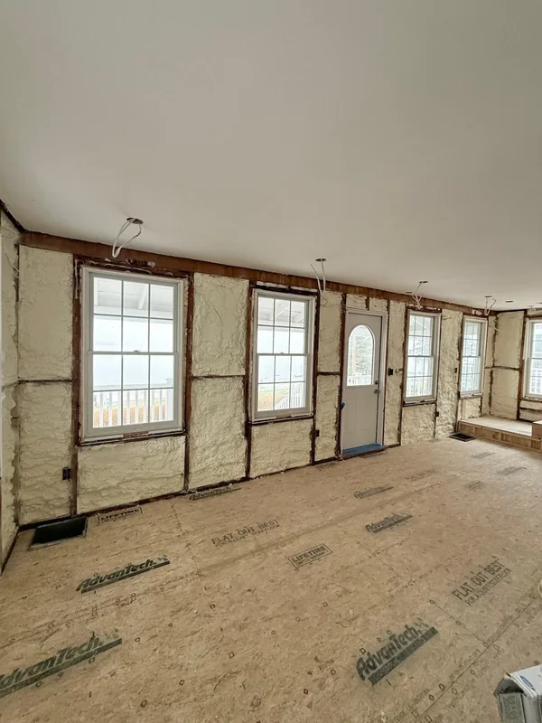 Interior room with spray foam insulation installed in wall cavities