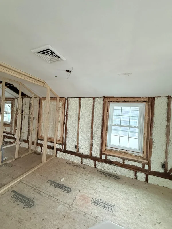 Room under renovation with spray foam insulation in exterior walls