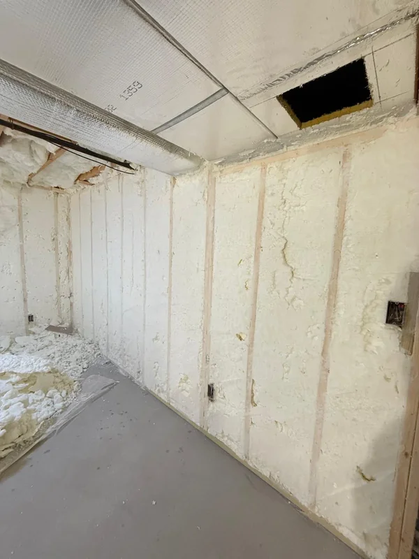 Room with finished spray foam insulation on walls and ceiling edges