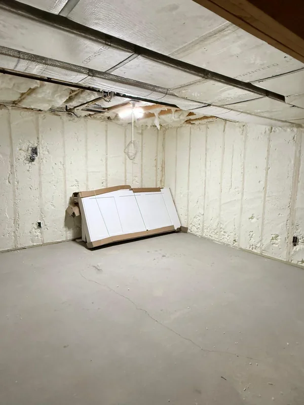 Bright basement room with spray foam insulated walls